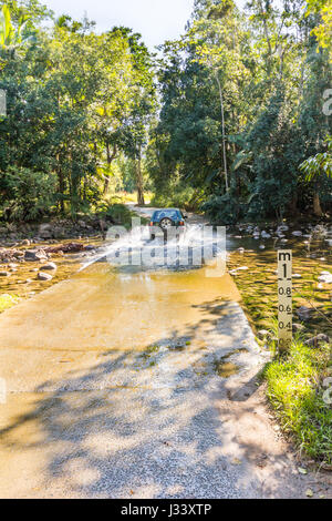 Car driving through a ford in Queensland, Australia Stock Photo