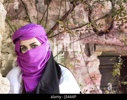 Portrait of beautiful and enigmatic young woman wearing hiyab looking at camera. Stock Photo