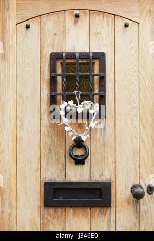 Traditional wooden front door of a house with ironmongery Stock Photo