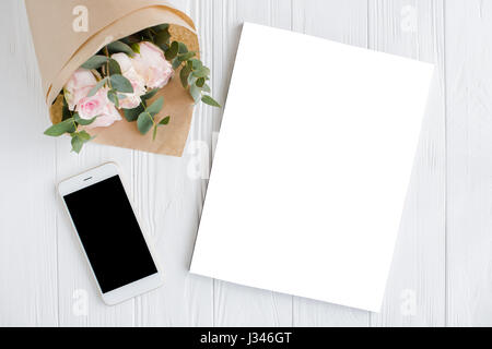 Romantic feminine background with smartphote, roses and magazine cover mock-up on white textured tabletop, lady blogger workspace Stock Photo