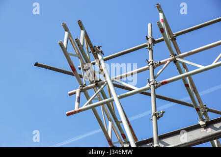 metal scaffolding in building and blue sky background Stock Photo