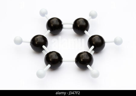 Plastic ball-and-stick model of a benzene molecule (C6H6) on a white background. The molecule is shown with kekule structure. Stock Photo