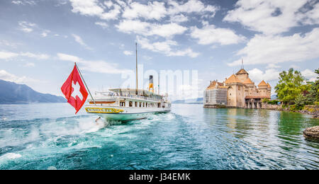 Traditional paddle steamer excursion ship with historic Chateau de Chillon at famous Lake Geneva on a sunny day in summer, Canton of Vaud, Switzerland Stock Photo