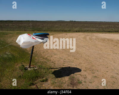 Empty garbage bag, agitated by the wind, in a desert landscape. Stock Photo