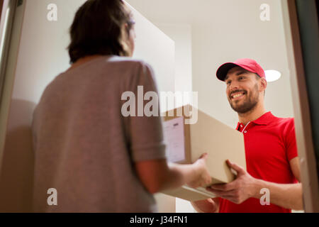 happy delivery man giving parcel box to customer Stock Photo