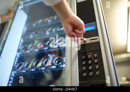 hand pushing button on vending machine Stock Photo