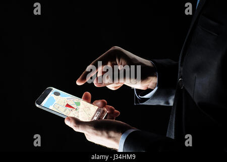close up of businessman with gps map on smartphone Stock Photo