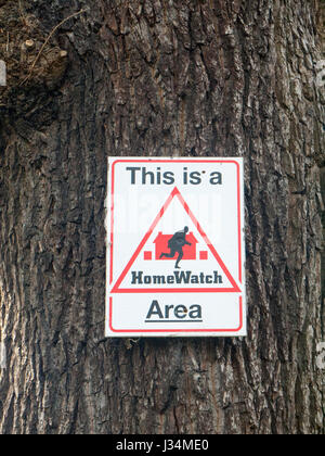 This is a homewatch area sign on tree UK Stock Photo