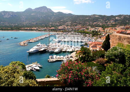 View of Calvi marina on Corsica, from the citadel. The rugged highlands of the islands interior are visible in the background. Stock Photo