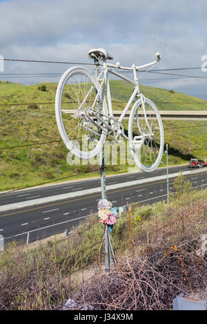 White ghost bike roadside memorial for killed cyclist  on Santiago Canyon Road in Orange County, California Stock Photo