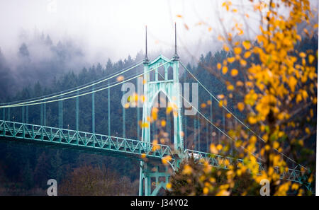 Gothic style arches tracery St Johns bridge Portland Oregon in the morning mist decorated with autumnal yellowed trees. Stock Photo