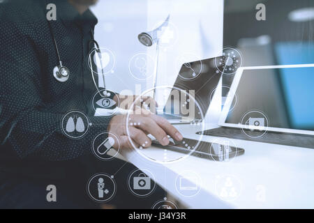 smart medical doctor working with smart phone and digital tablet and laptop computer and stethoscope on wood desk in modern office with virtual digita Stock Photo
