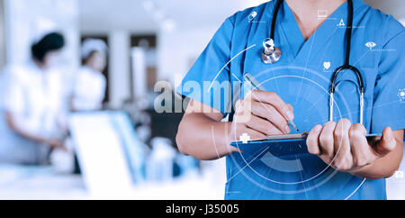 Smart medical doctor writing nformation patient medical on a clipboard at the hospital with VR icon diagram Stock Photo