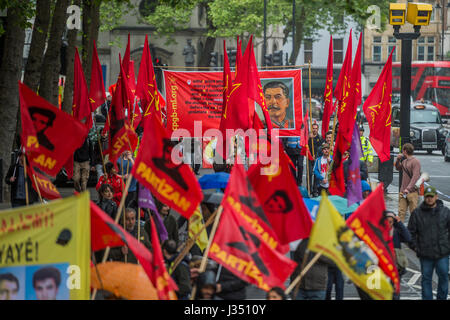 Members of the Communist Party of Great Britain show solidarity - he May Day March from Clerkenwell Green ending with a rally in Trafalgar Square - against cuts and anti 'Trade Union laws. It was supported by several trade unions including UNITE, PCS, ASLEF, RMT, TSSA, NUT, FBU, GMB and UNISON as well as the Peoples Assembly, Pensioners’ organisations and organisations representing migrant workers & communities. Stock Photo
