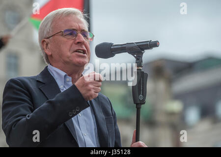 John Mcdonnell speaks - The May Day March from Clerkenwell Green ending with a rally in Trafalgar Square - against cuts and anti 'Trade Union laws. It was supported by several trade unions including UNITE, PCS, ASLEF, RMT, TSSA, NUT, FBU, GMB and UNISON as well as the Peoples Assembly, Pensioners’ organisations and organisations representing migrant workers & communities. Stock Photo