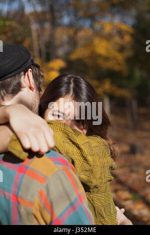 Happy young couple embracing in a park Stock Photo