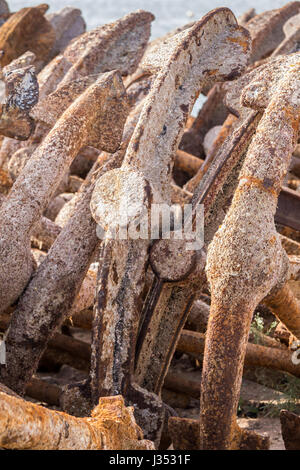 rusty old anchor in the port of Barbate, Cadiz, Spain. These anchors are used in the draft of nets for traditional fishing of bluefin tuna. Stock Photo