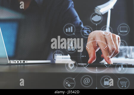 businessman using digital tablet and laptop computer and document in modern office with virtual interface graphic icons network diagram Stock Photo