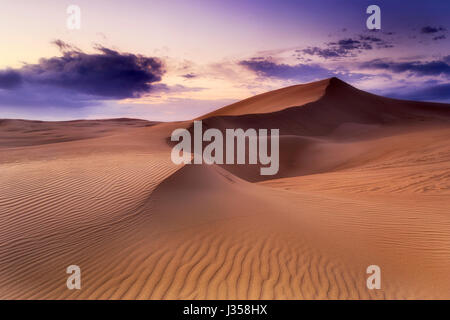 Lifeless sand desert with chain of dunes at sunrise. Stockton beach sand dunes in NSW, Australia. Stock Photo