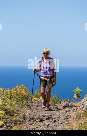 Older woman walker on a walking trail above Los silos in the Teno Masif, north tenerife, Canary Islands, Spain Stock Photo