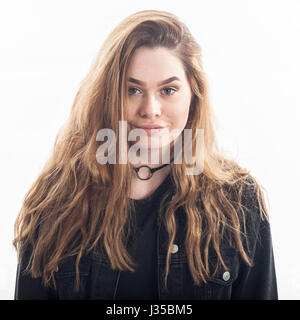 A pretty 15 year old girl in the studio against a white backdrop in the Uk Stock Photo