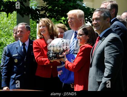 Washington, United States. 02nd May, 2017. U.S. President Donald Trump poses with the Air Force Academy football helmet during the presentation of the Commander-in-Chief's Trophy in the Rose Garden of the White House May 2, 2017. Standing with the president are: Left to Right: Air Force Chief of Staff Gen. David Goldfein, Acting Secretary of the Air Force Lisa Disbrow, retired Air Force Col. Rep. Martha McSally and unidentified. Credit: Planetpix/Alamy Live News