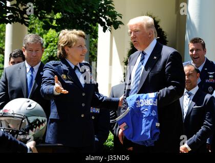 Washington, United States. 02nd May, 2017. U.S. Lt. Gen. Michelle Johnson, superintendent of the U.S. Air Force Academy, presents President Donald Trump with a team helmet during the presentation of the Commander-in-Chief's Trophy in the Rose Garden of the White House May 2, 2017. Credit: Planetpix/Alamy Live News Stock Photo