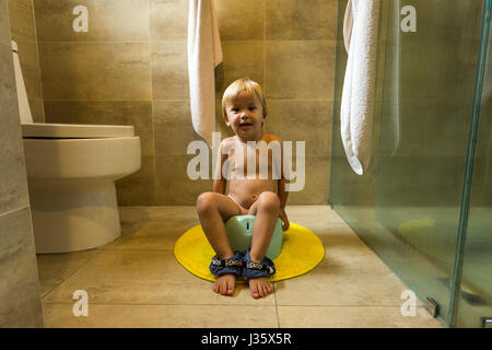 A 2 year old bit sits on the potty Stock Photo
