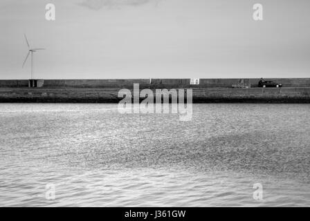 Cat parked on pier at Blyth harbour Stock Photo