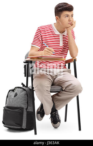 Bored teenage student sitting in a school chair isolated on white background Stock Photo