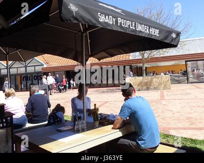 Family snacking under an umbrella Stock Photo