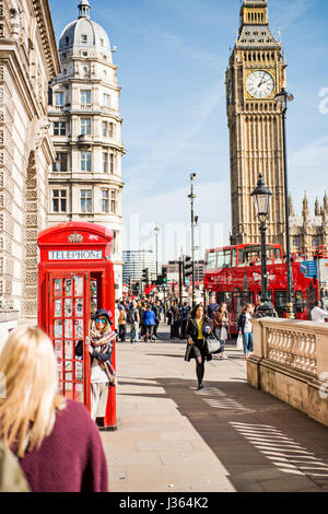 Tourist posing with red phone box with Big Ben in the background Stock Photo