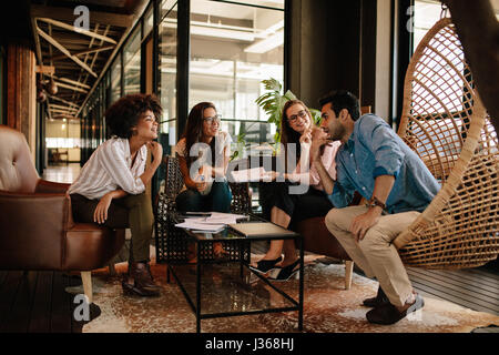 Team of corporate professionals having discussion in meeting. Multi ethnic business team having project discussion. Stock Photo