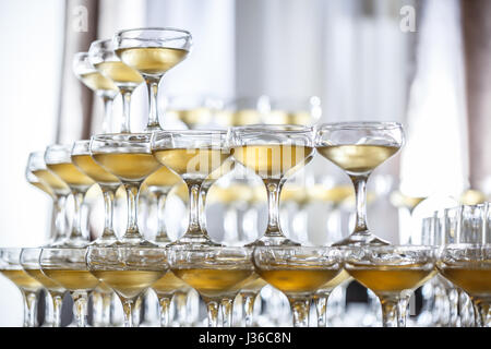 Champagne glasses standing in a tower at the party Stock Photo