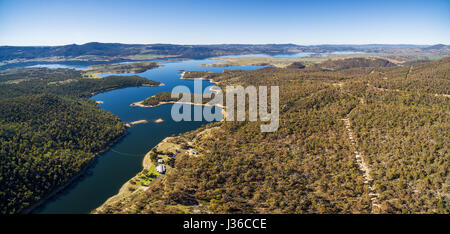 Aerial panorama of Snowy River flowing among green hills of Australian Alps and lake Jindabyne Stock Photo