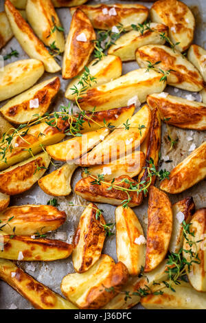 Young baked potatoes with herbs Stock Photo