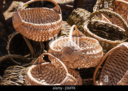 Pile of hand made wicker buskets on display for sale at a local fair. Nobody around. Stock Photo