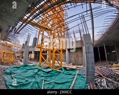 yellow crane in the core of the building Stock Photo