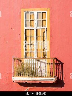 Grass and weeds growing on balcony of derelict building in Spain Stock Photo