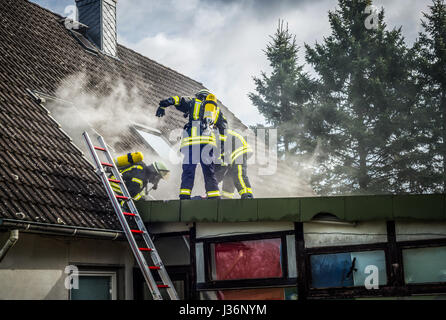 Firefighters extinguish a house fire in the teamwork - HDR Stock Photo