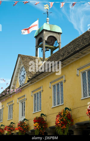 Summer flowers decorate the historic old Market Hall in Tetbury, Gloucestershire, UK Stock Photo