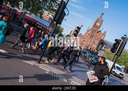 People crossing Euston Road after exiting King's Cross station in the morning, London, England, U.K. Stock Photo