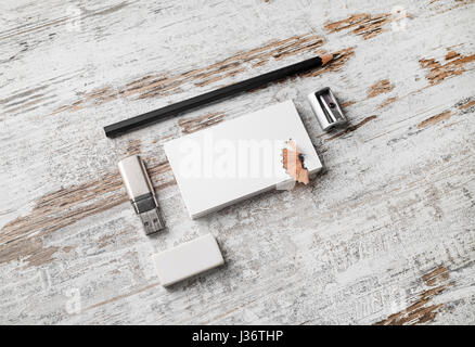 Blank paperwork template for designers. Responsive design mockup. Bank business cards, pencil, eraser, flash drive and sharpener on vintage wood table Stock Photo
