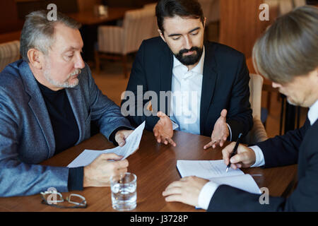Businessman Working Hard in Restaurant Stock Photo
