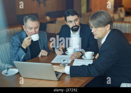Working on Business Presentation with Colleagues Stock Photo