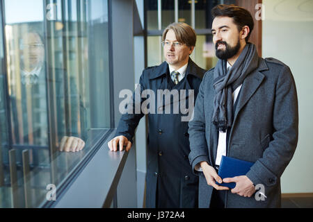 Enjoying View from Office Building Window Stock Photo