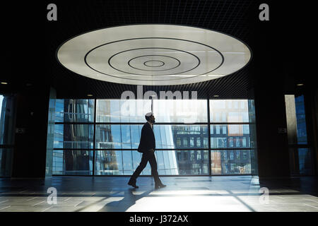 Walking Along Office Corridor Stock Photo
