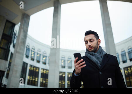 Modern Businessman  Using Smartphone Outdoors Stock Photo