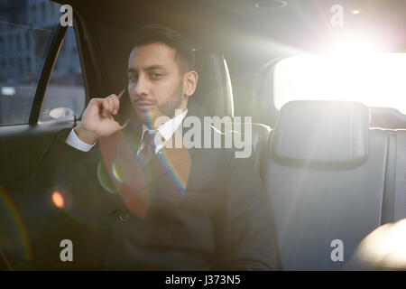 Confident Businessman Calling by Phone from Car Stock Photo