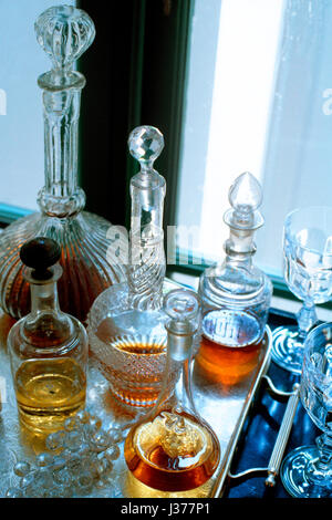 Assorted range of antique bottles with alcohol. Stock Photo